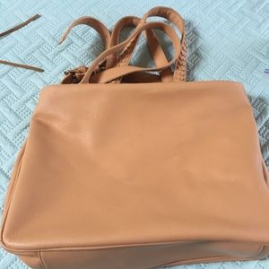 Tan colored shoulder bag.